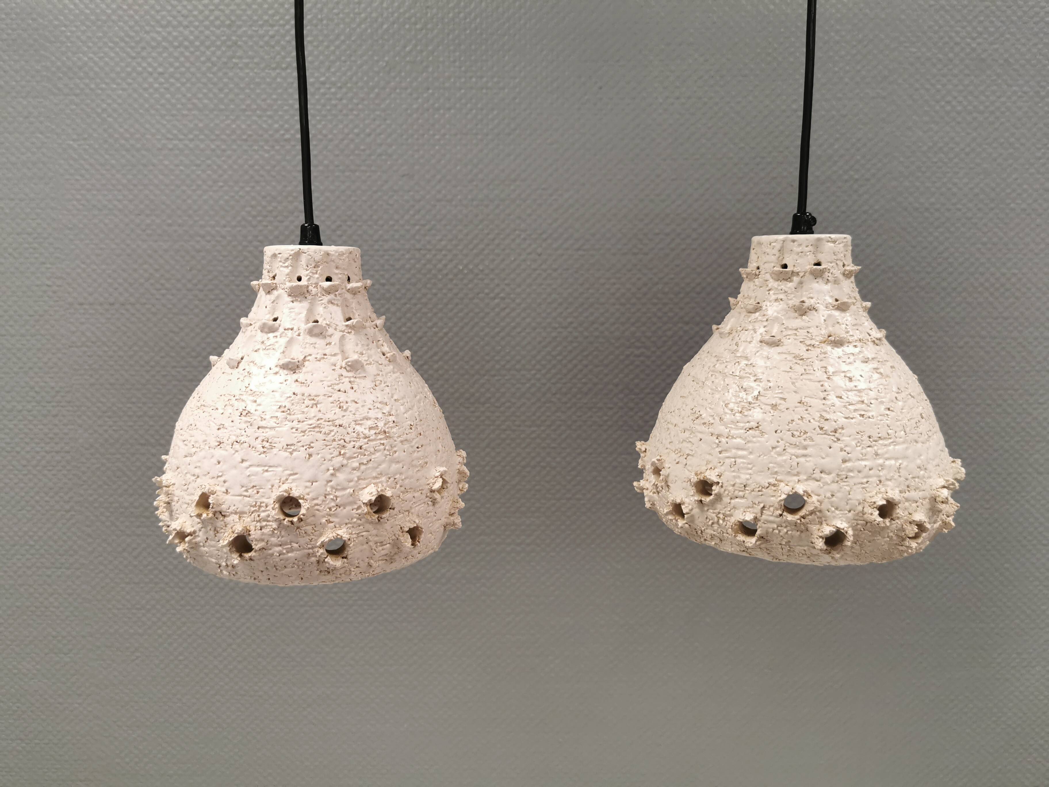 Two ceramic hanging lamps, in creamy white color, looking almost like coral