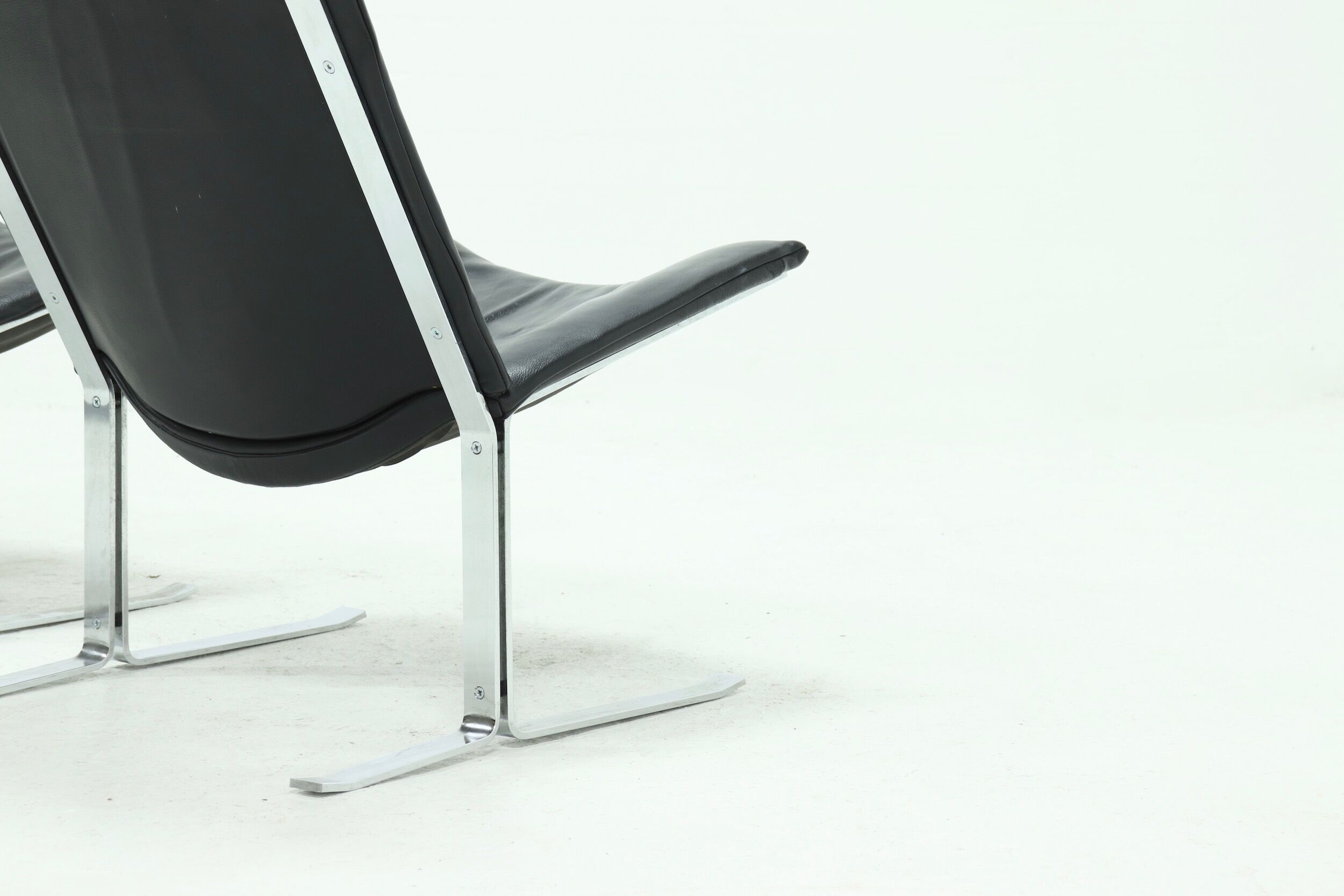 Set of 2 Danish lounge chairs by Kebe Møbler model Eagle with black leather.