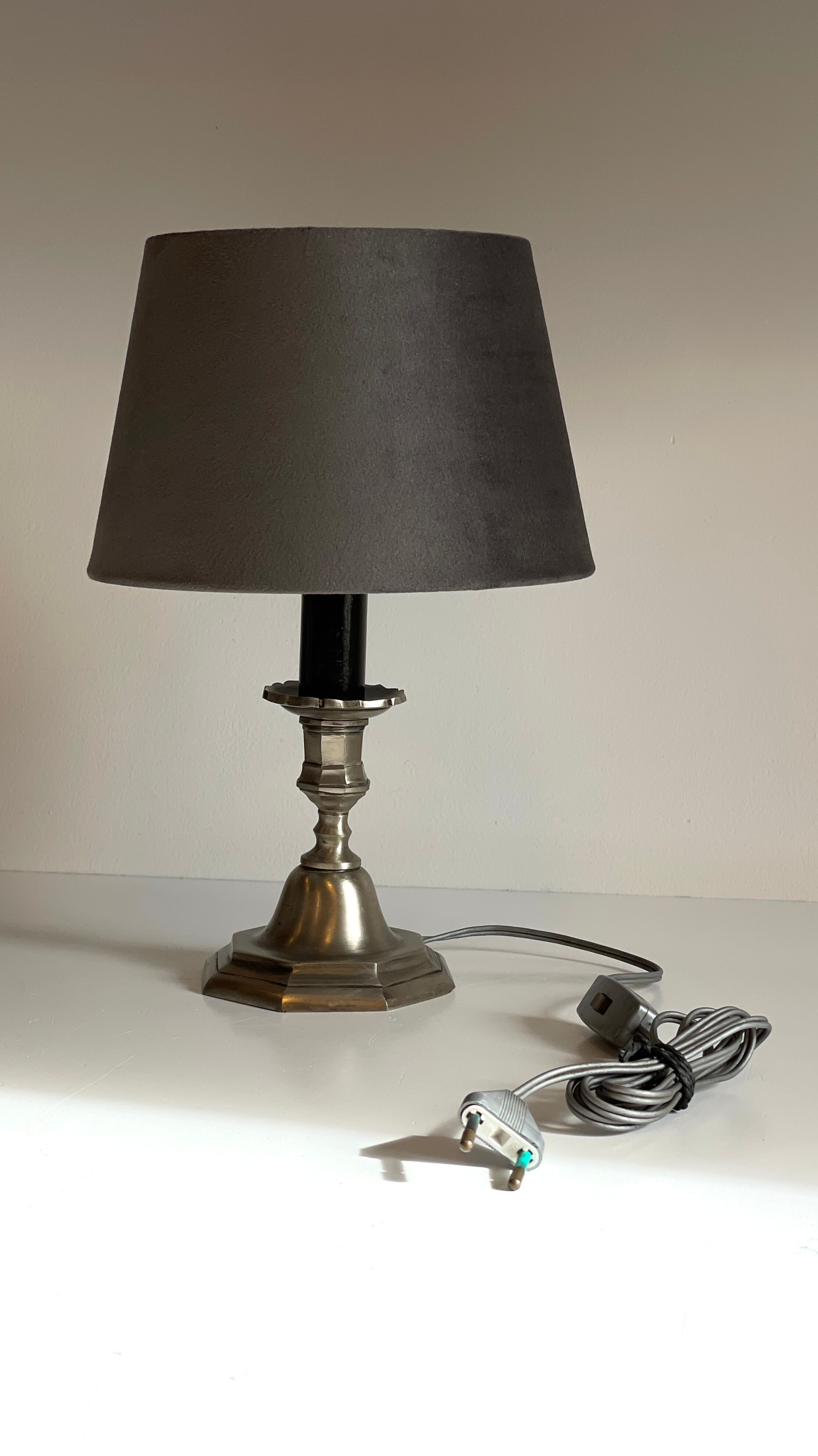 Steel candlestick lamp and grey velvet