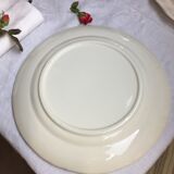 Old dish of ivory color and round shape with a chantourné edge.