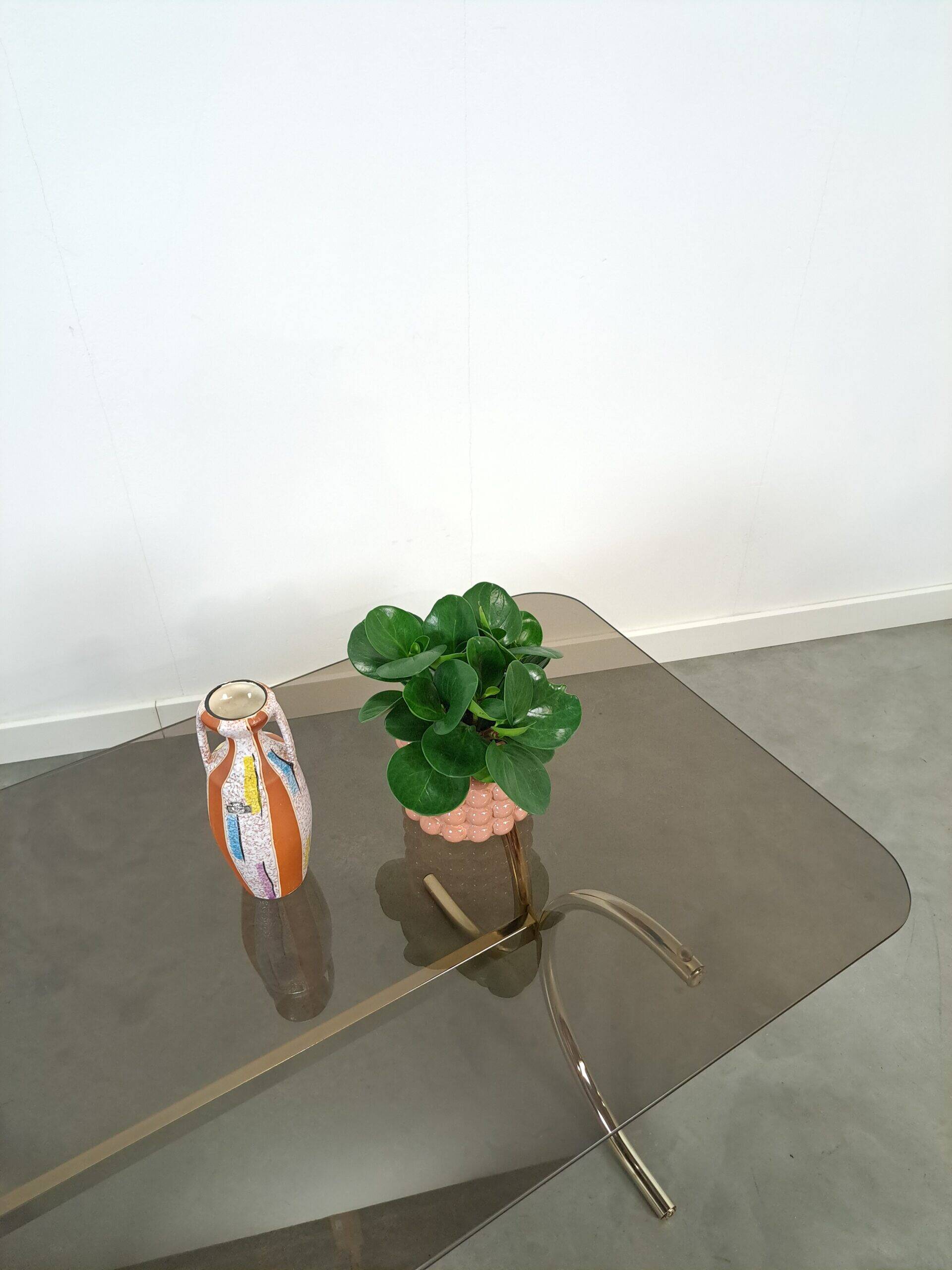 Smoked glass coffee table with gold-coloured legs from Sweden