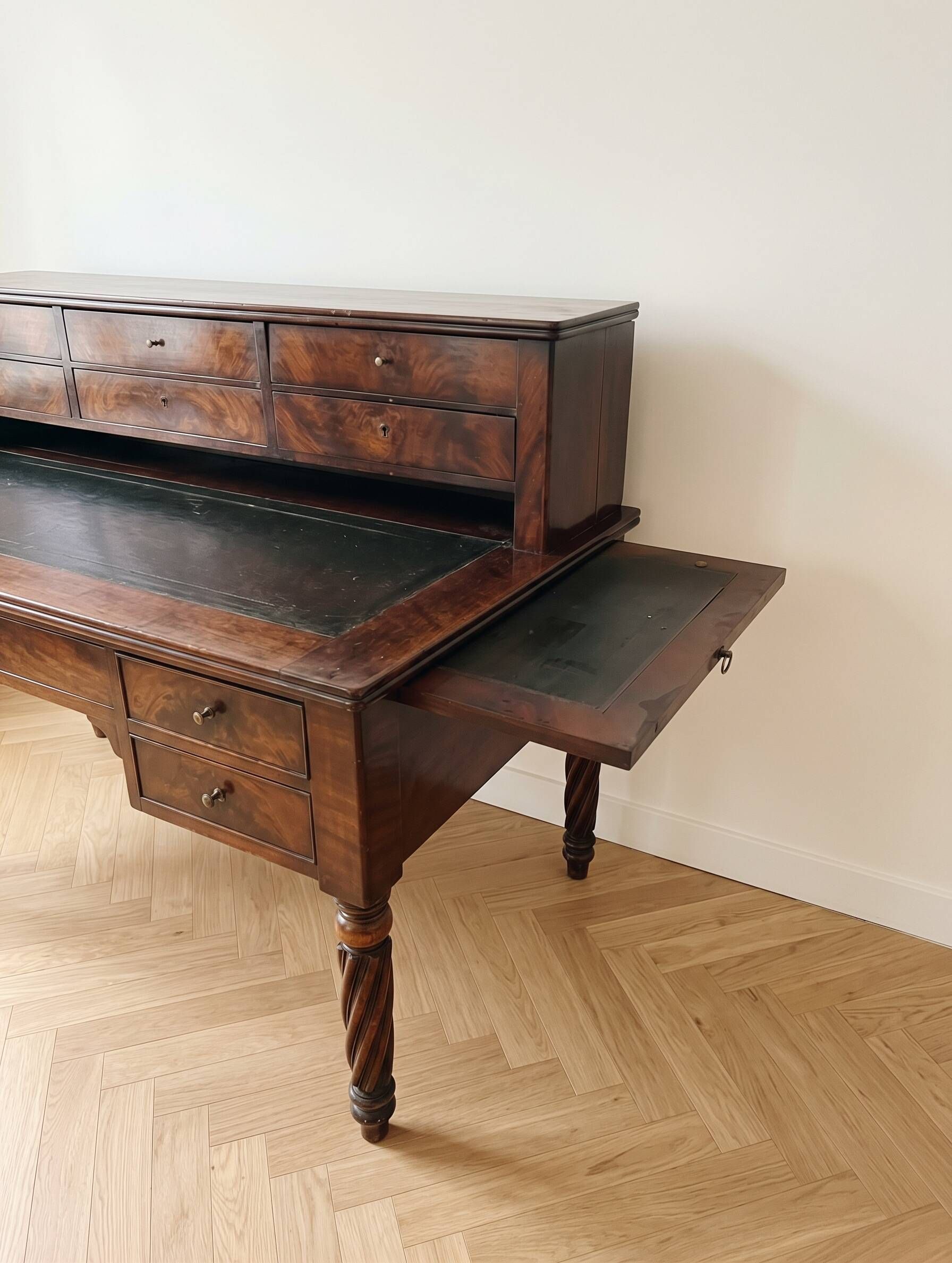 Antique wooden tiered desk with drawers and twisted legs.