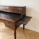 Antique wooden tiered desk with drawers and twisted legs.