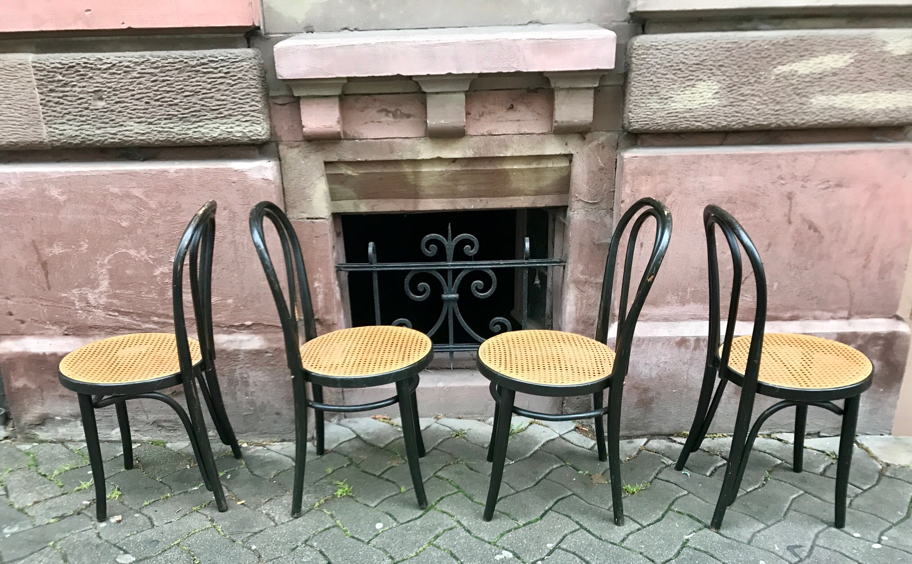 Two pairs of black 50s chairs - number 18 - cannée