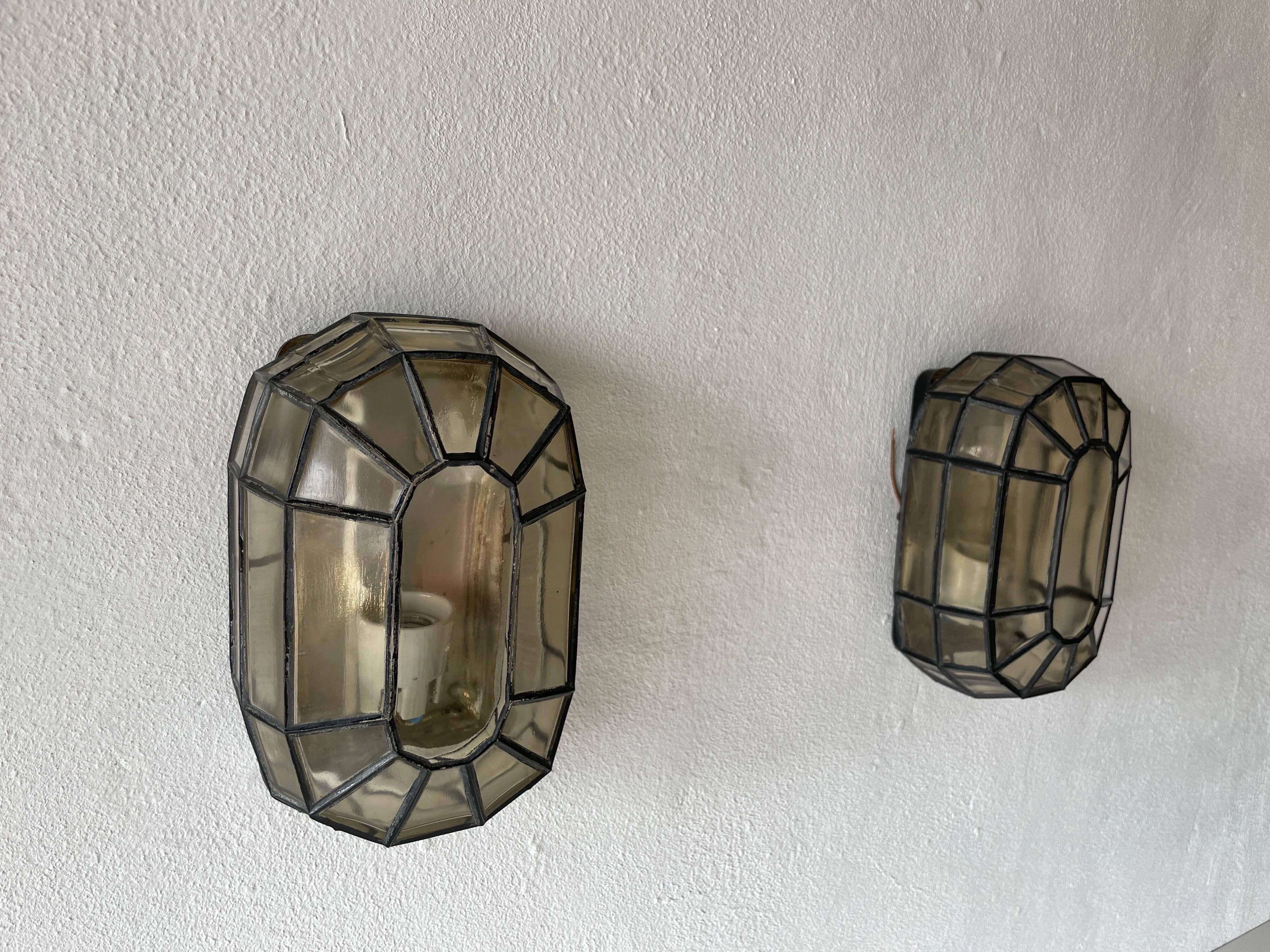 Pair of black iron wall sconces with structured glass by Limburg, 1960s, Germany.
