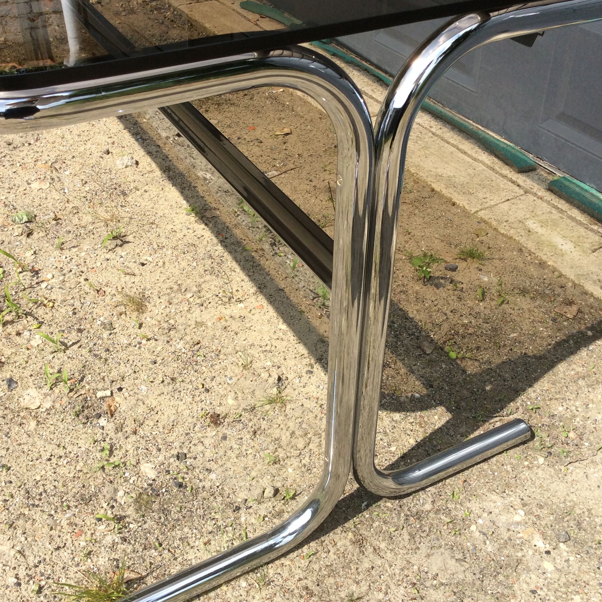 Dining table of the 70s in smoked glass and chromed metal
