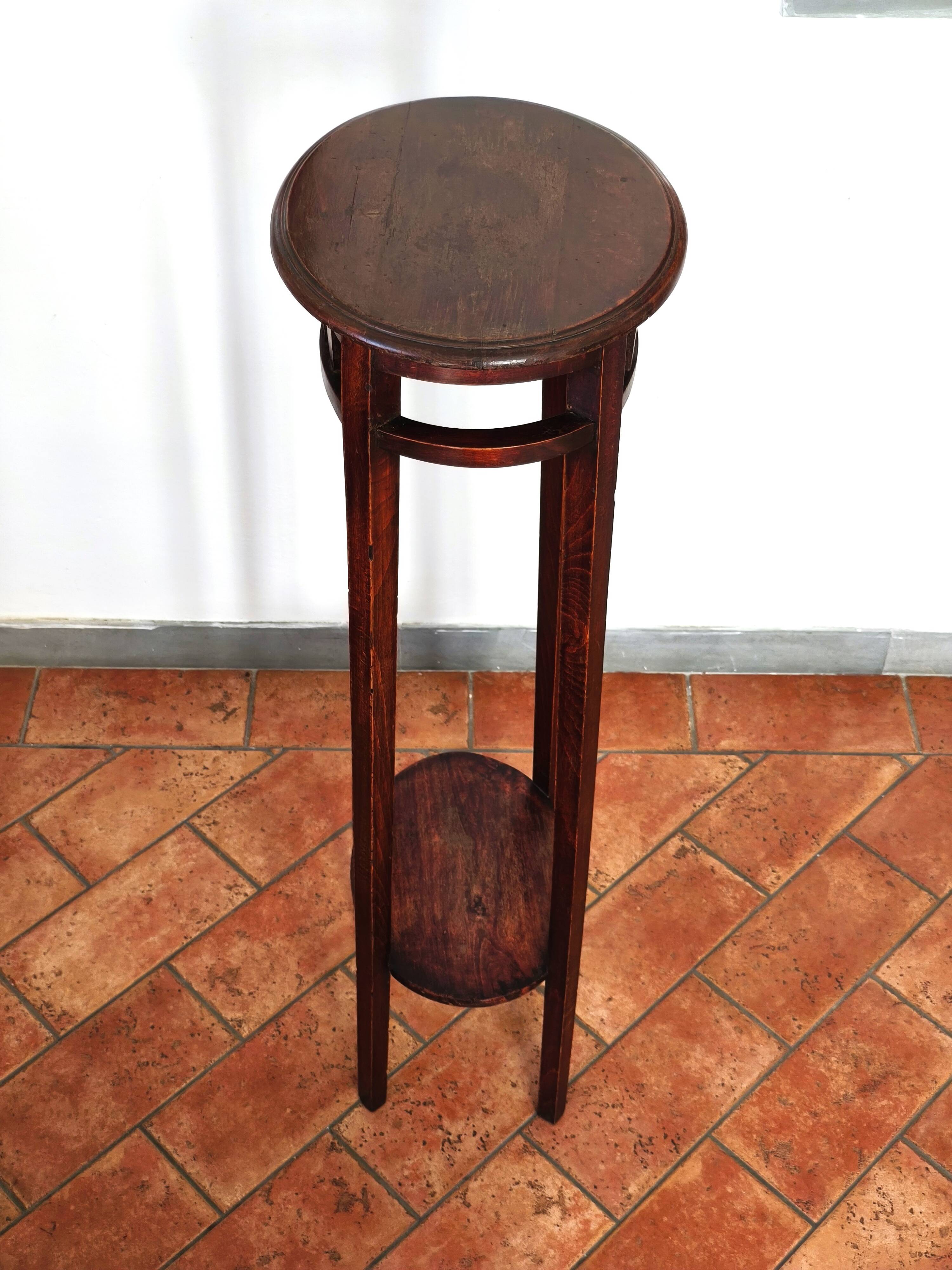 Antique high wooden pedestal with mahogany patina, circa 1900-1925.