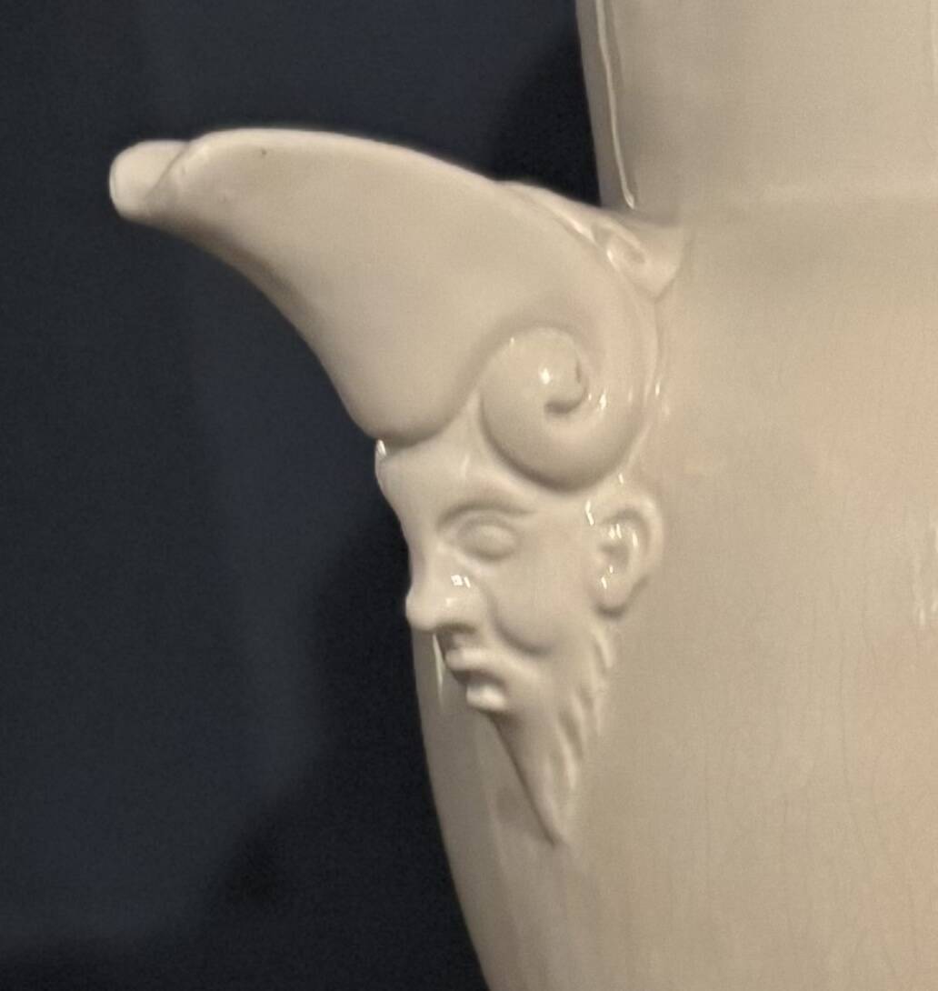 Large white faience jug with a satyr head spout, 19th century.