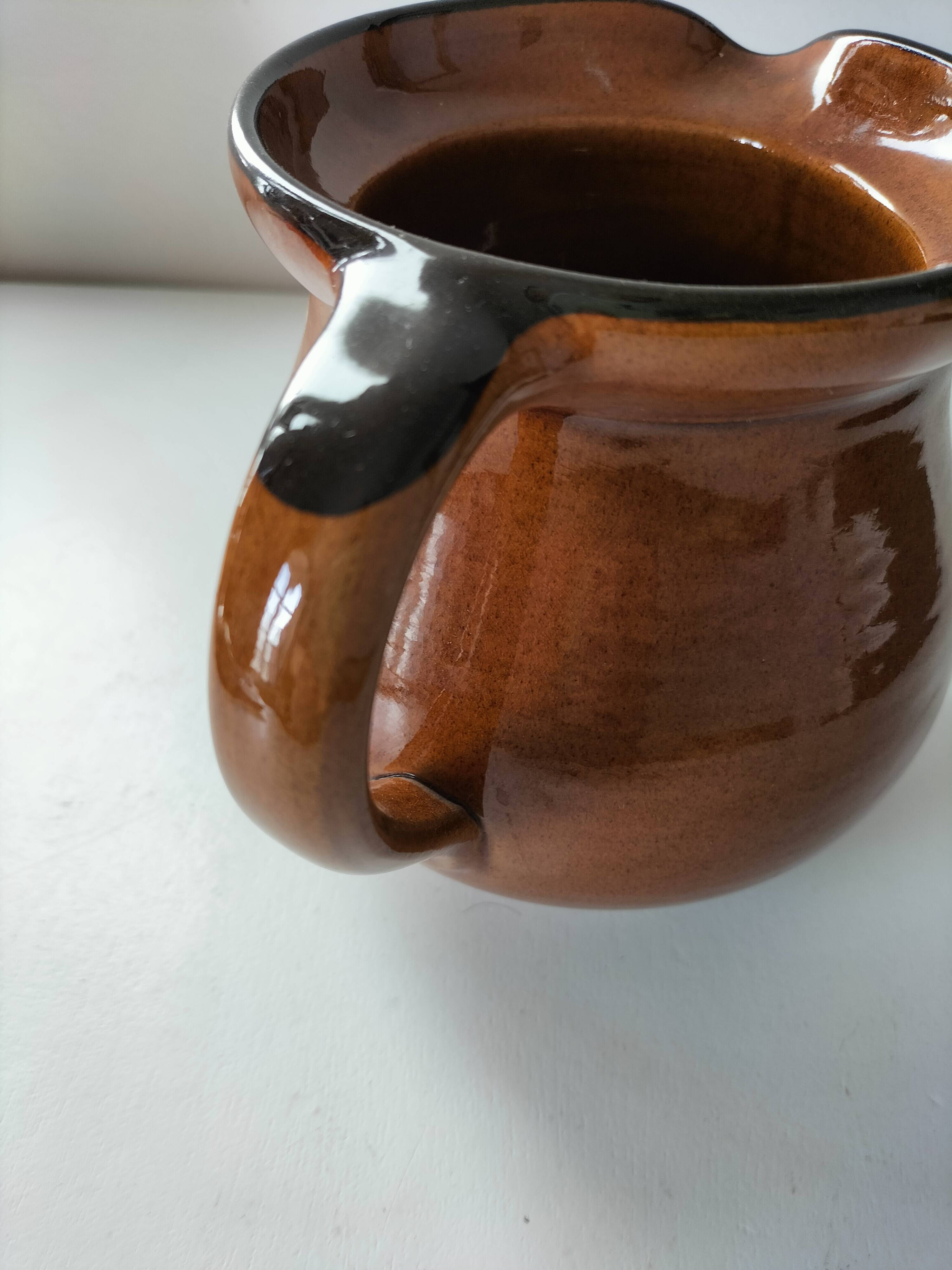 Glazed earthenware pitcher signed HR with a design of stylised birds.