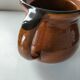 Glazed earthenware pitcher signed HR with a design of stylised birds.