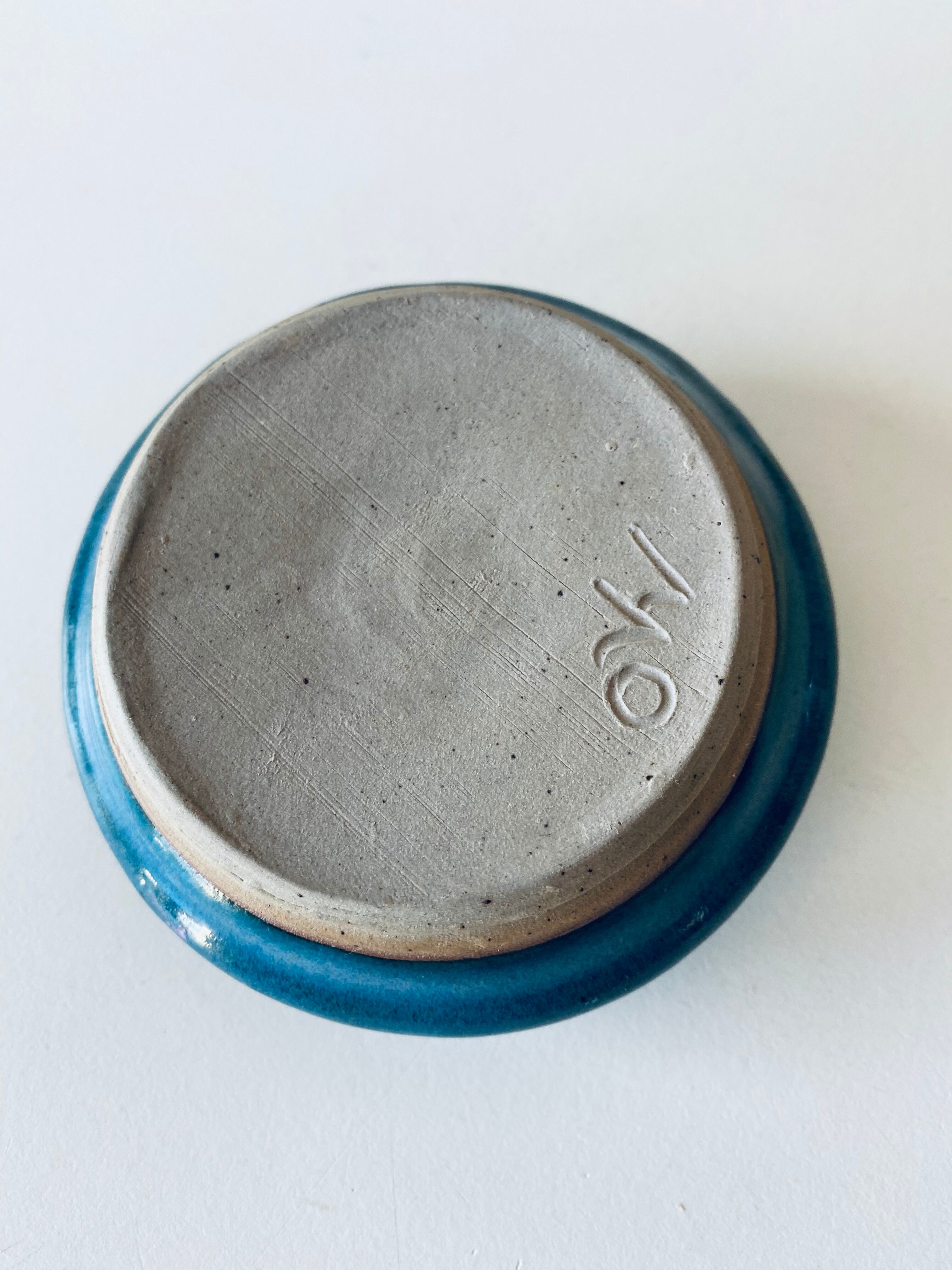 Blue enamelled sandstone candlestick