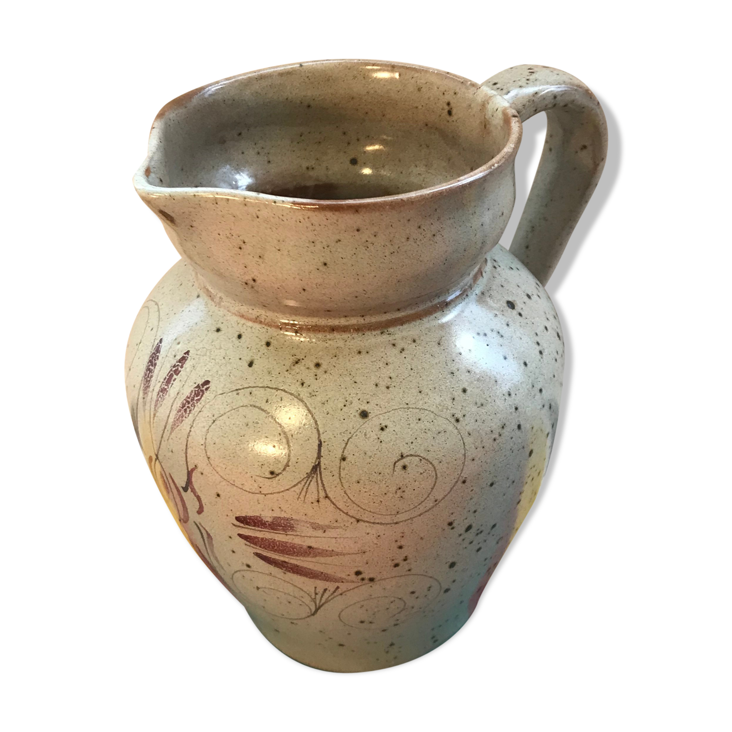 Old gray pitcher with black drawings and vintage stamped handle