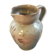 Old gray pitcher with black drawings and vintage stamped handle