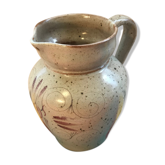 Old gray pitcher with black drawings and vintage stamped handle