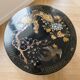 Asian coffee table in Chinese style made of black and gold lacquered wood.