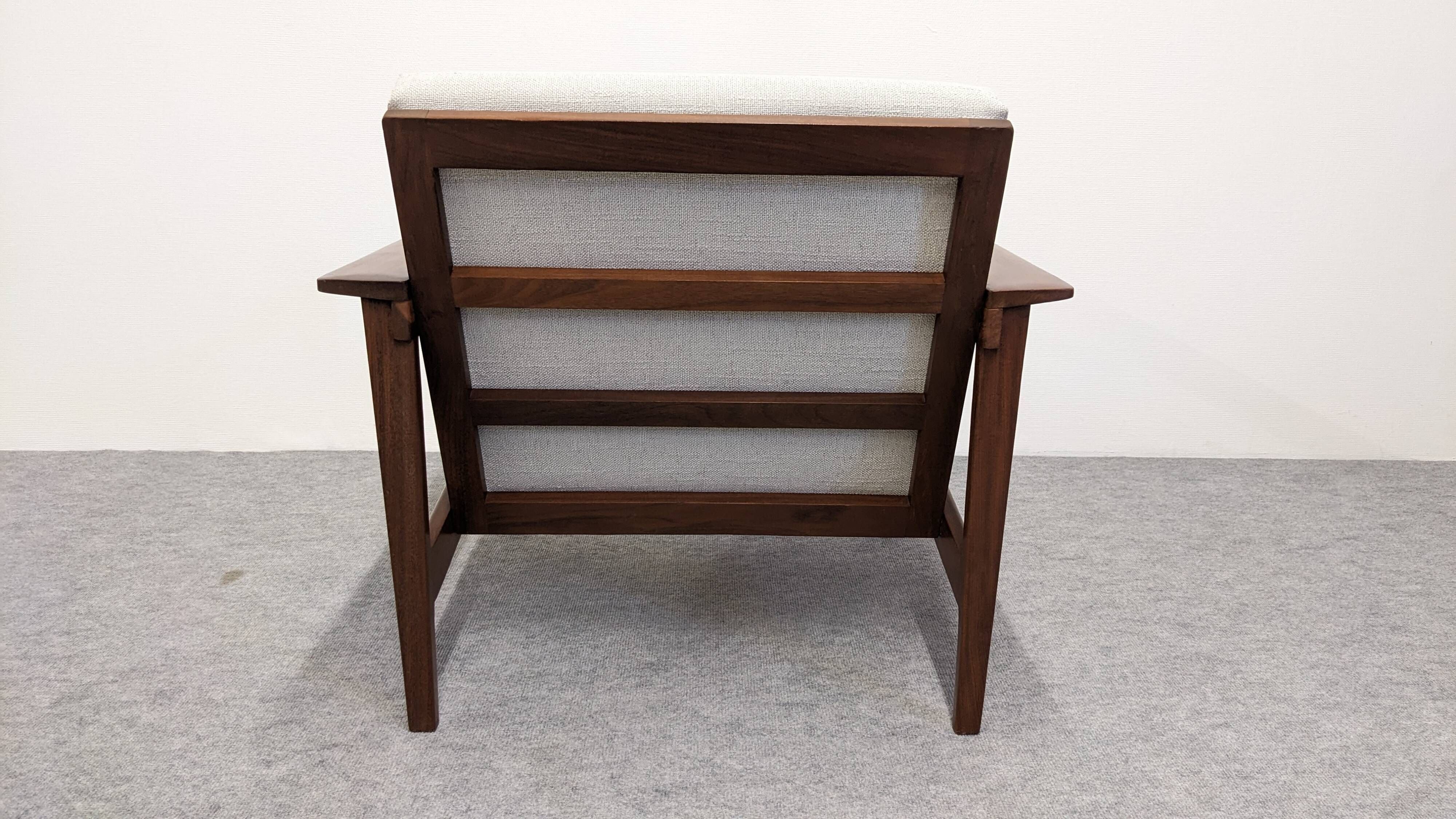 Living room, three-seater sofa and two armchairs, modernist in teak, France around 1950.