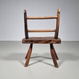 Rustic Wabi-Sabi style accent chair in dark curved hardwood, 1900s.