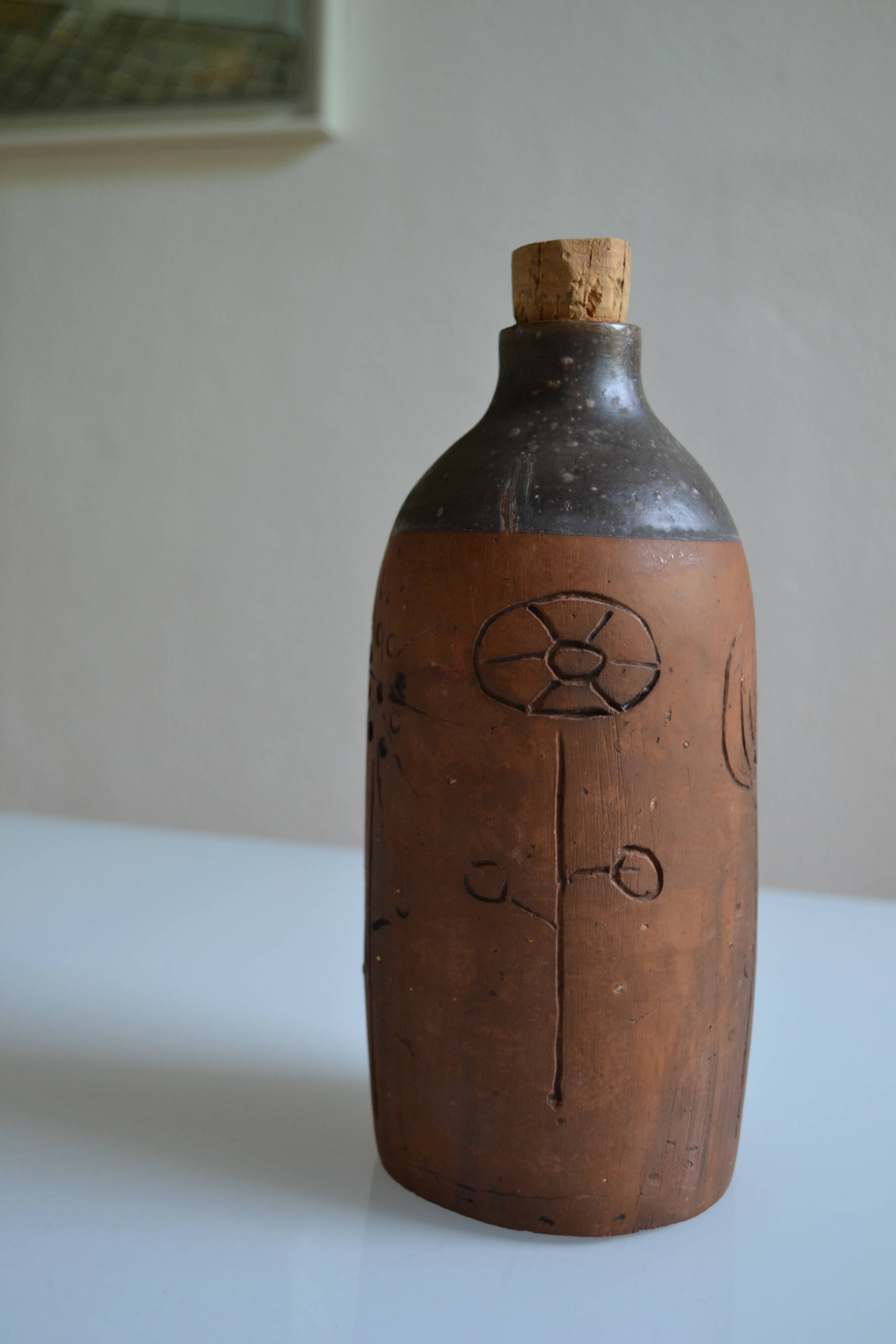 Bottle vase decorative flowers ceramic signature with fish to identify.