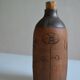 Bottle vase decorative flowers ceramic signature with fish to identify.
