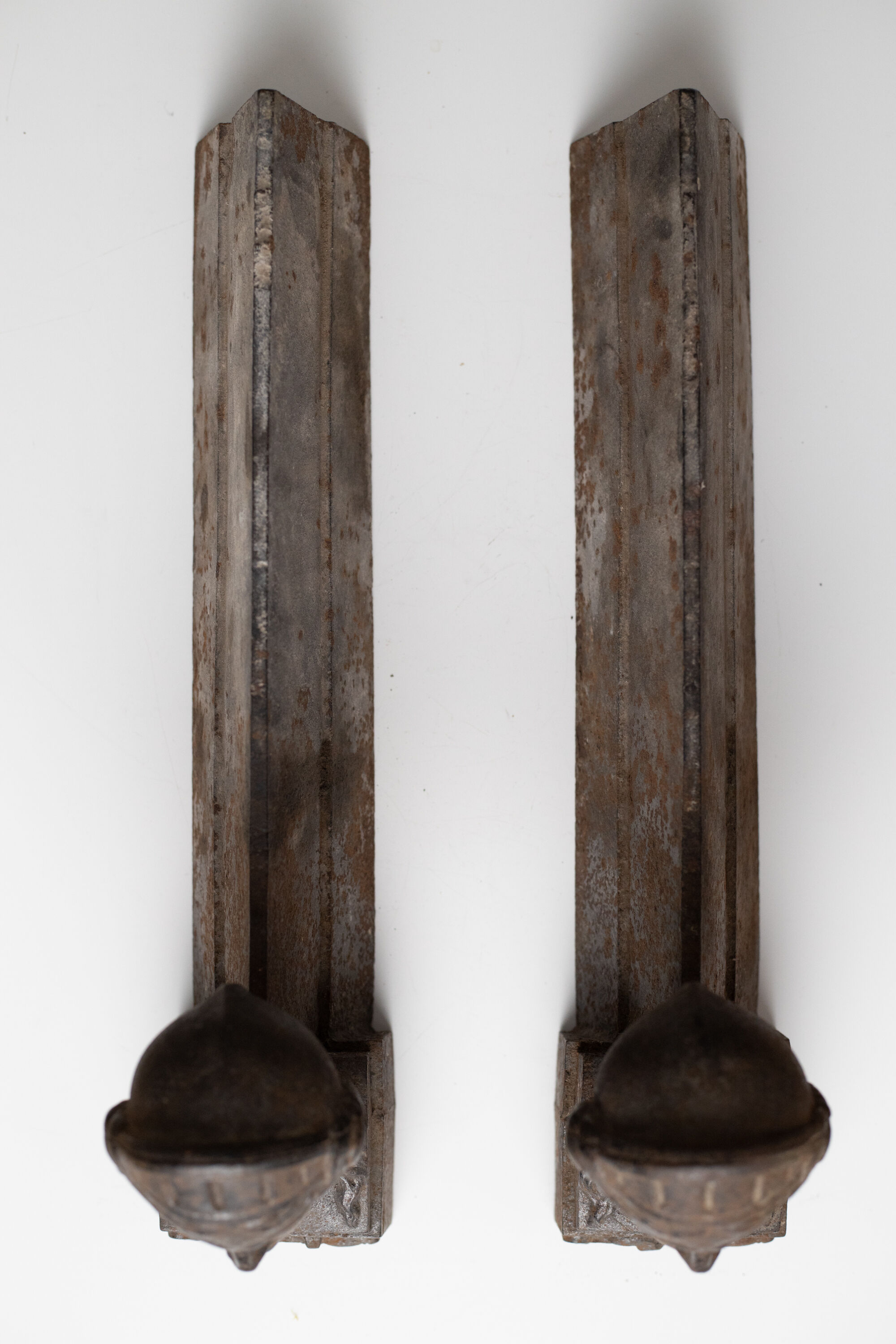 Pair of ancient cast iron chenets adorned with bust of Marianne