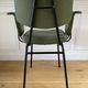 Vintage chair with green imitation leather armrests