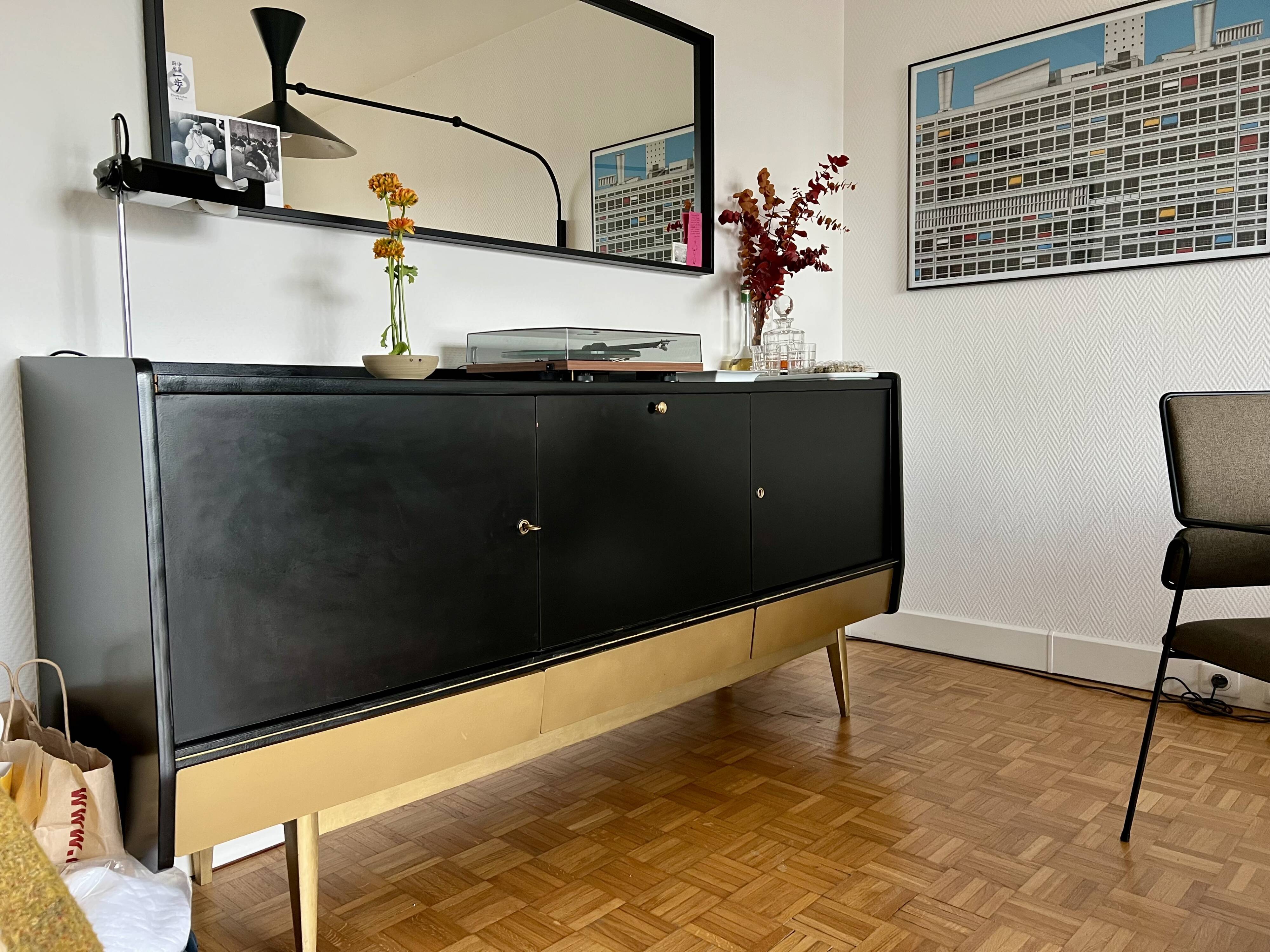 Black buffet cabinet including a bar and 3 drawers.