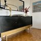 Black buffet cabinet including a bar and 3 drawers.