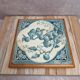 Antique trivet in Gien tile with blue bird decoration – wooden border
