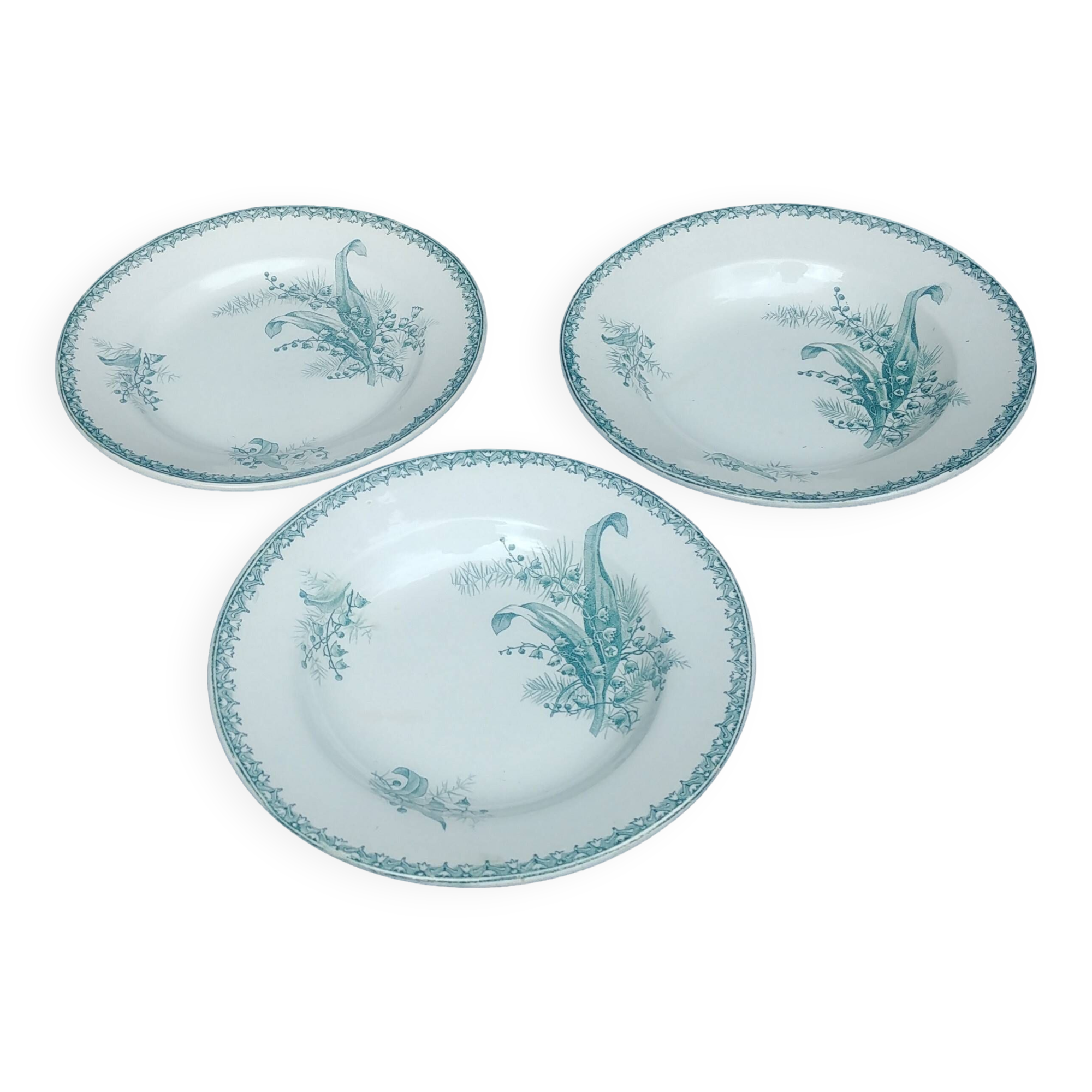 Set of three iron earthenware plates from the St Amandinoise earthenware factory, lily of the valley model.