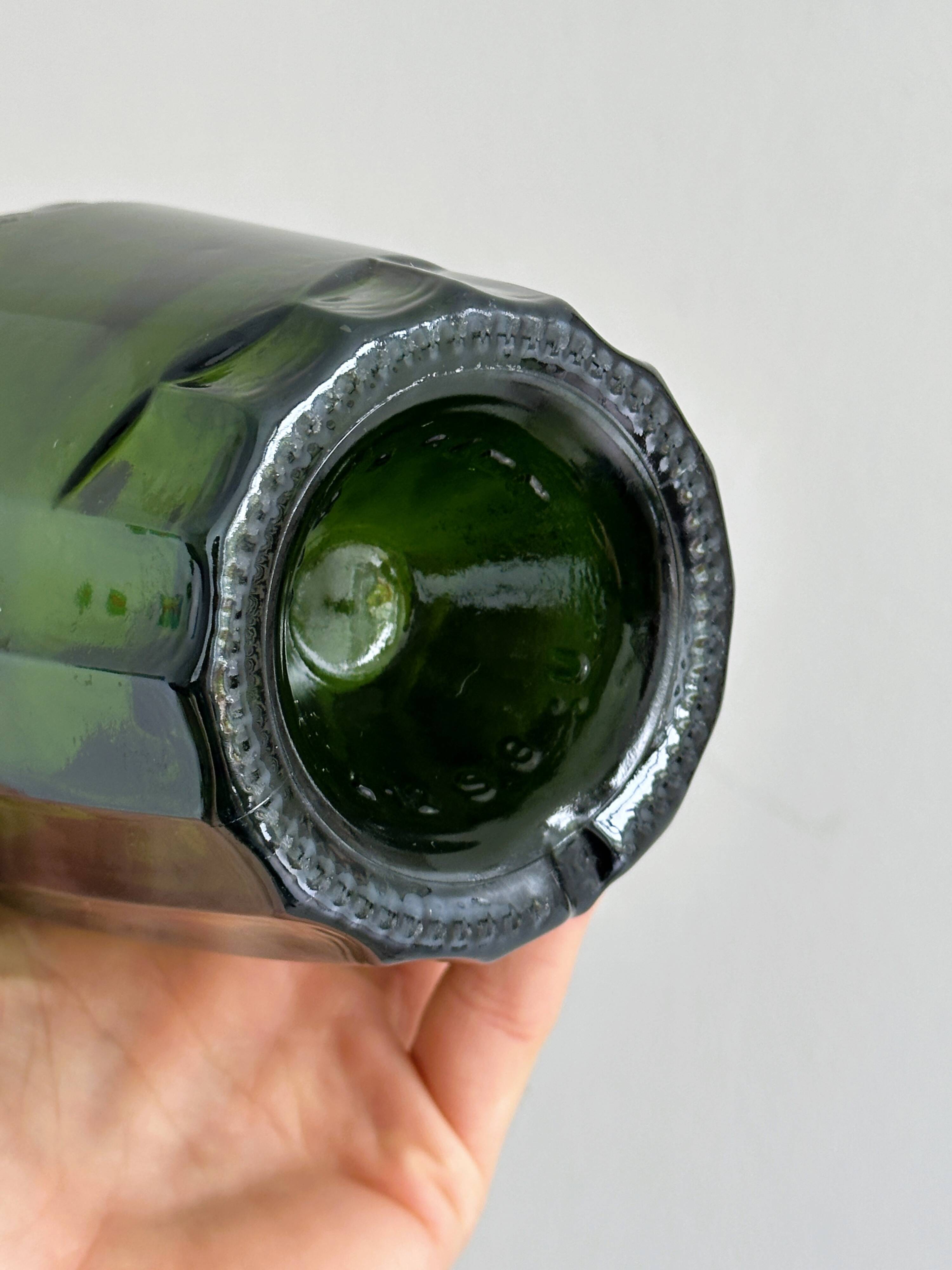 Translucent green glass bottle, classic design.