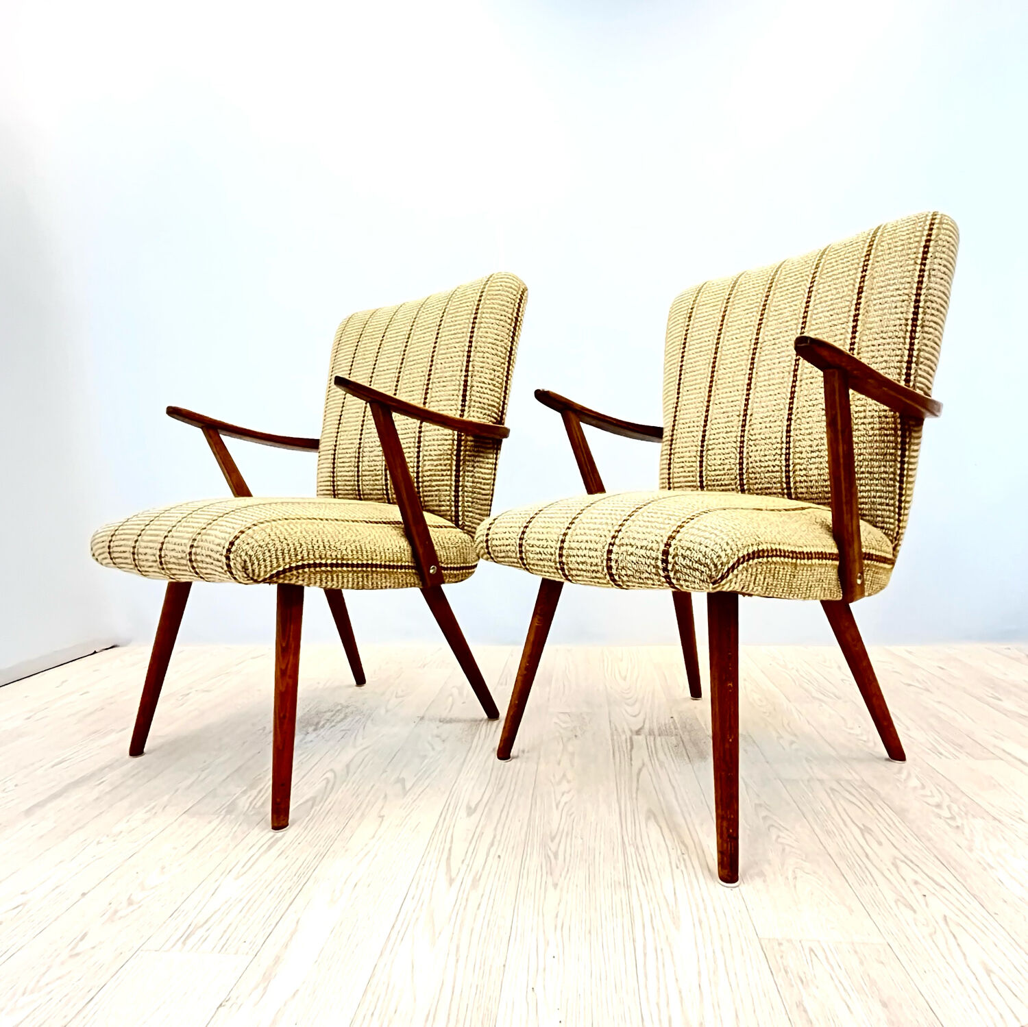 A pair vintage cocktail chairs with stripes and metal screws