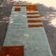 Handmade orange and white wool rug, traditionally crafted, size 140 x 260 cm