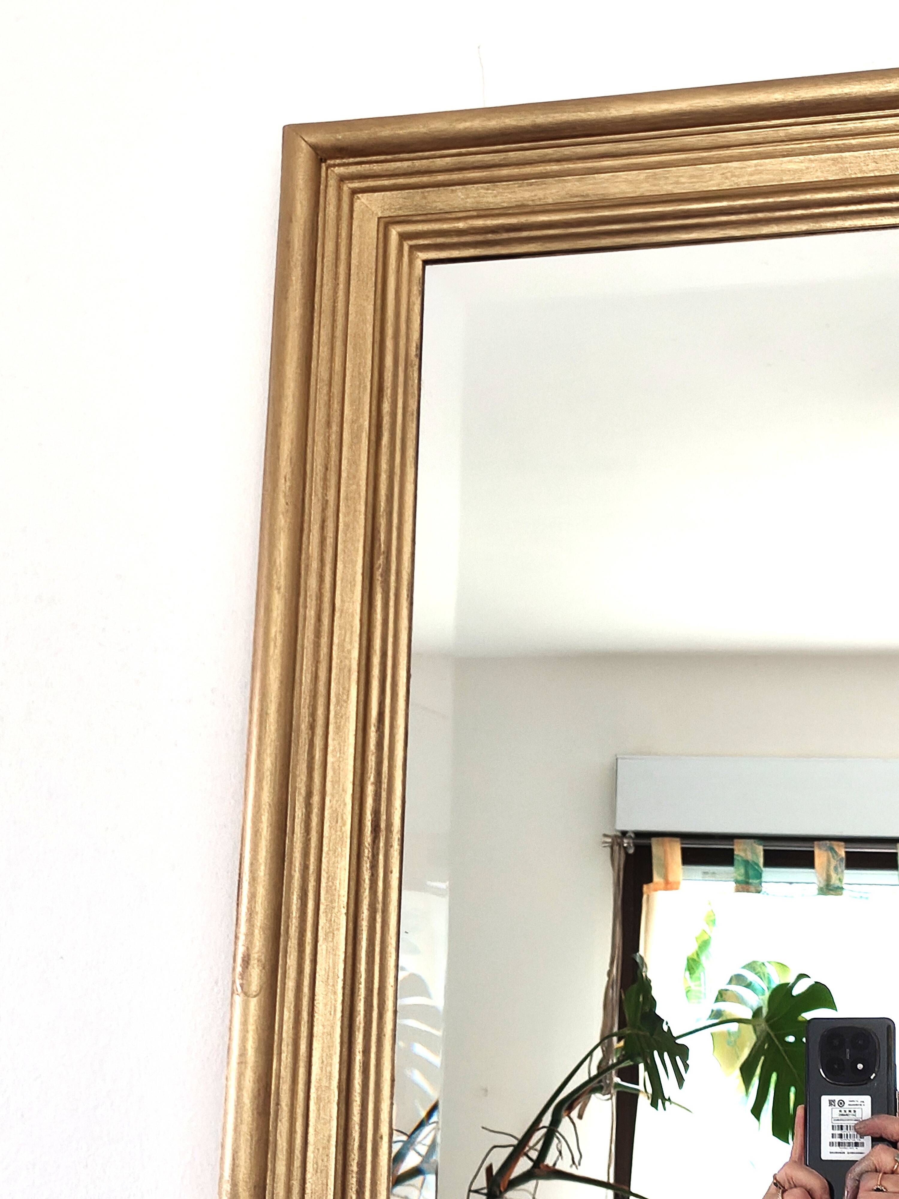 Large gold-framed mirror with bevelled glass.