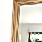 Large gold-framed mirror with bevelled glass.