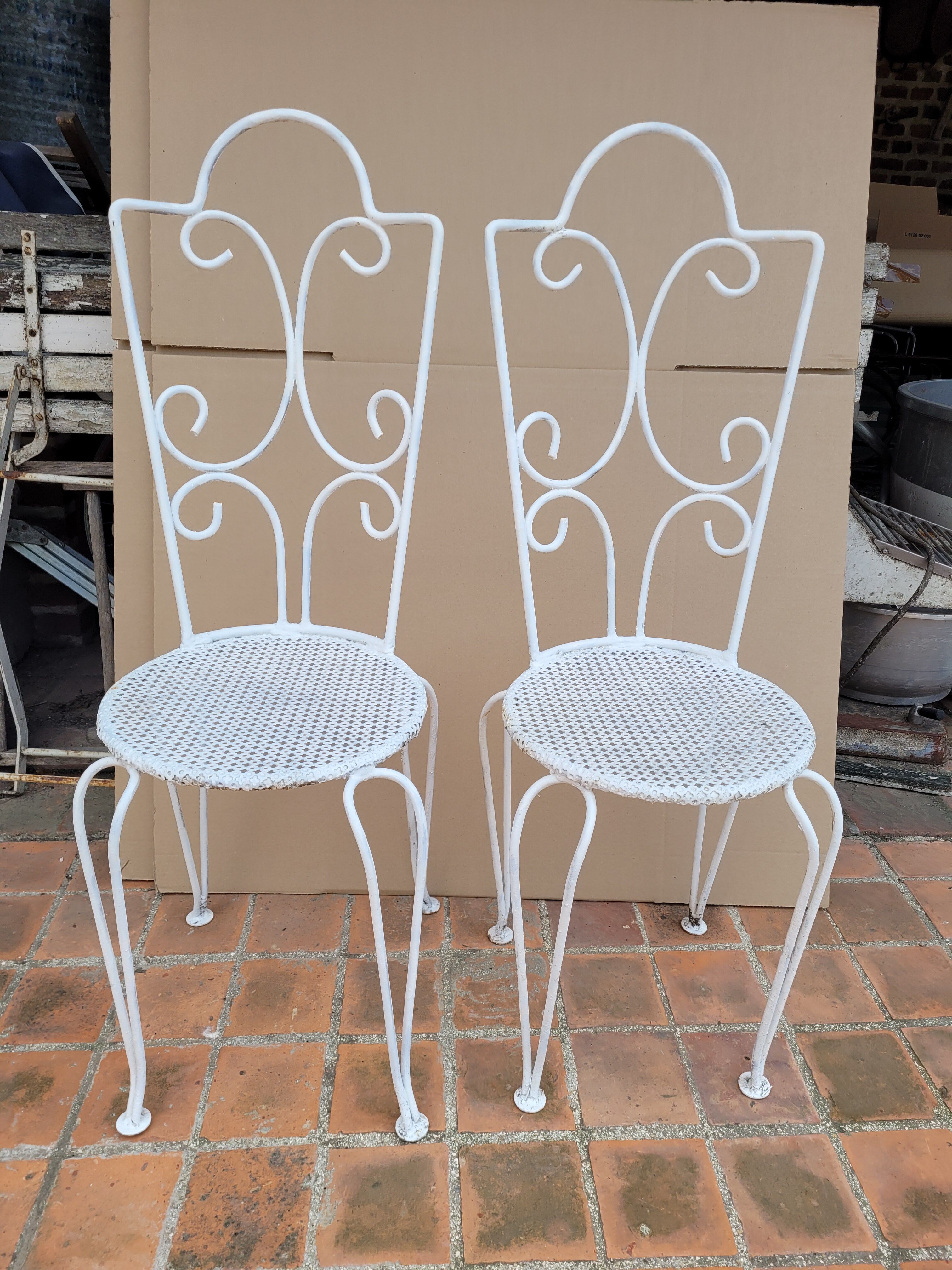 Pair of antique wrought iron garden chairs