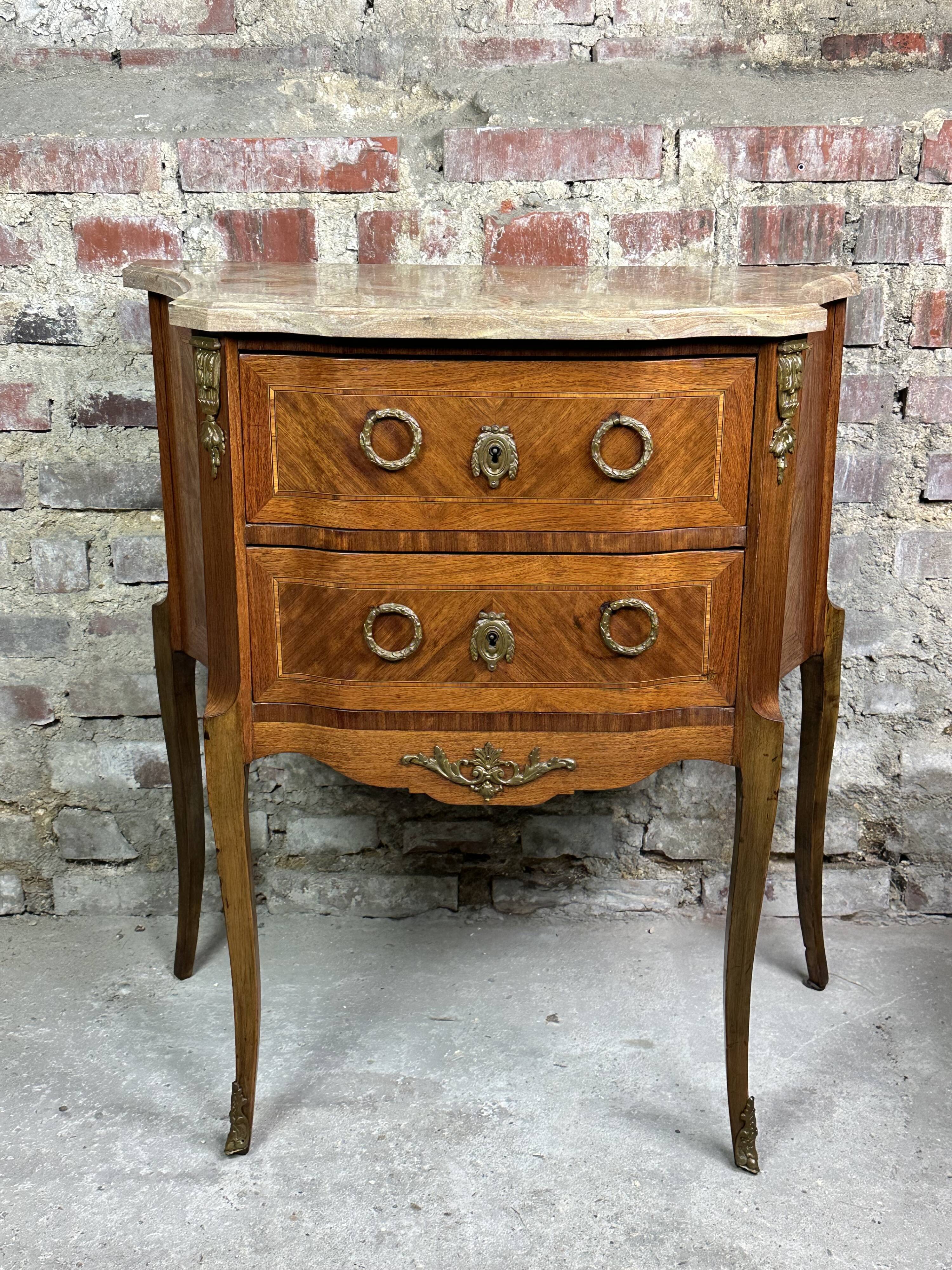 Louis XV/XVI transition style curved chest of drawers in marquetry and bronze