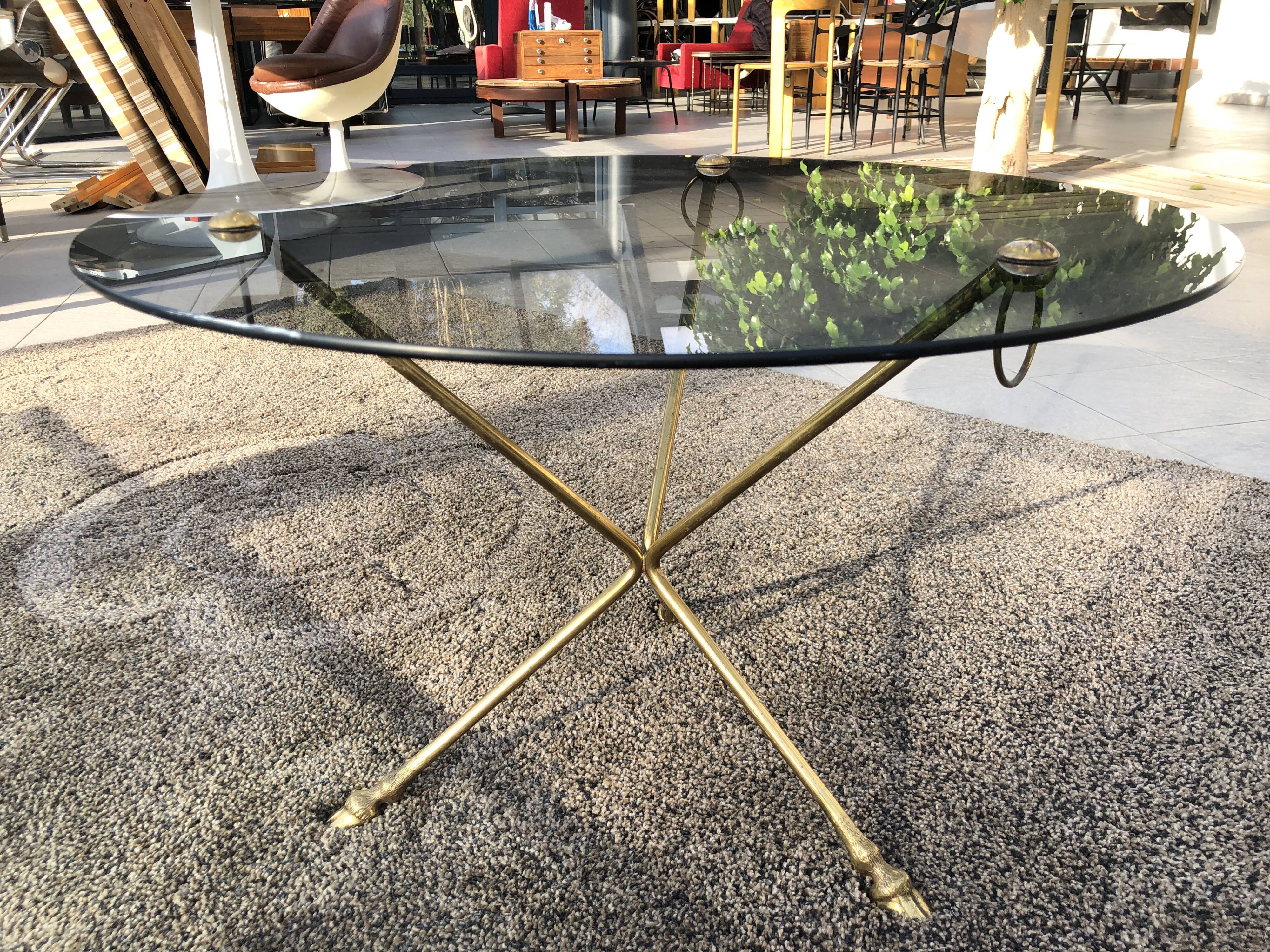 Glass and brass coffee table with hoof-shaped tripod legs, 1970