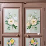 Large antique wardrobe painted with floral decoration.