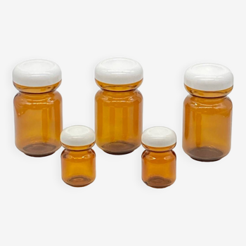 Series of vintage amber glass jars