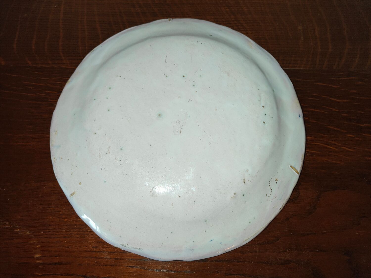 Old earthenware plate of the North XVIIIth Century with floral decoration