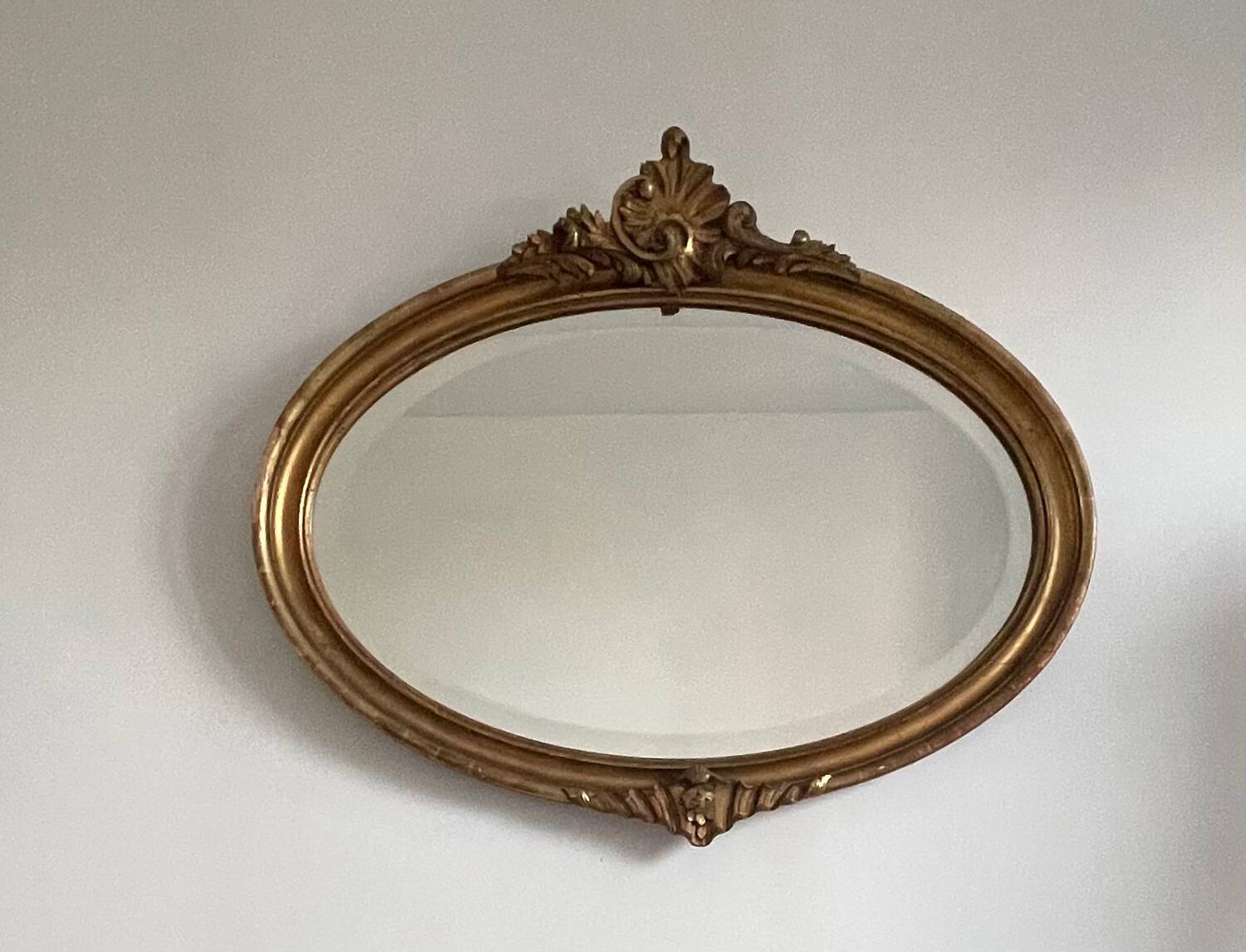 Antique oval gilt mirror.