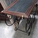 Pair of wrought iron and blackened wood consoles from the mid-20th century.