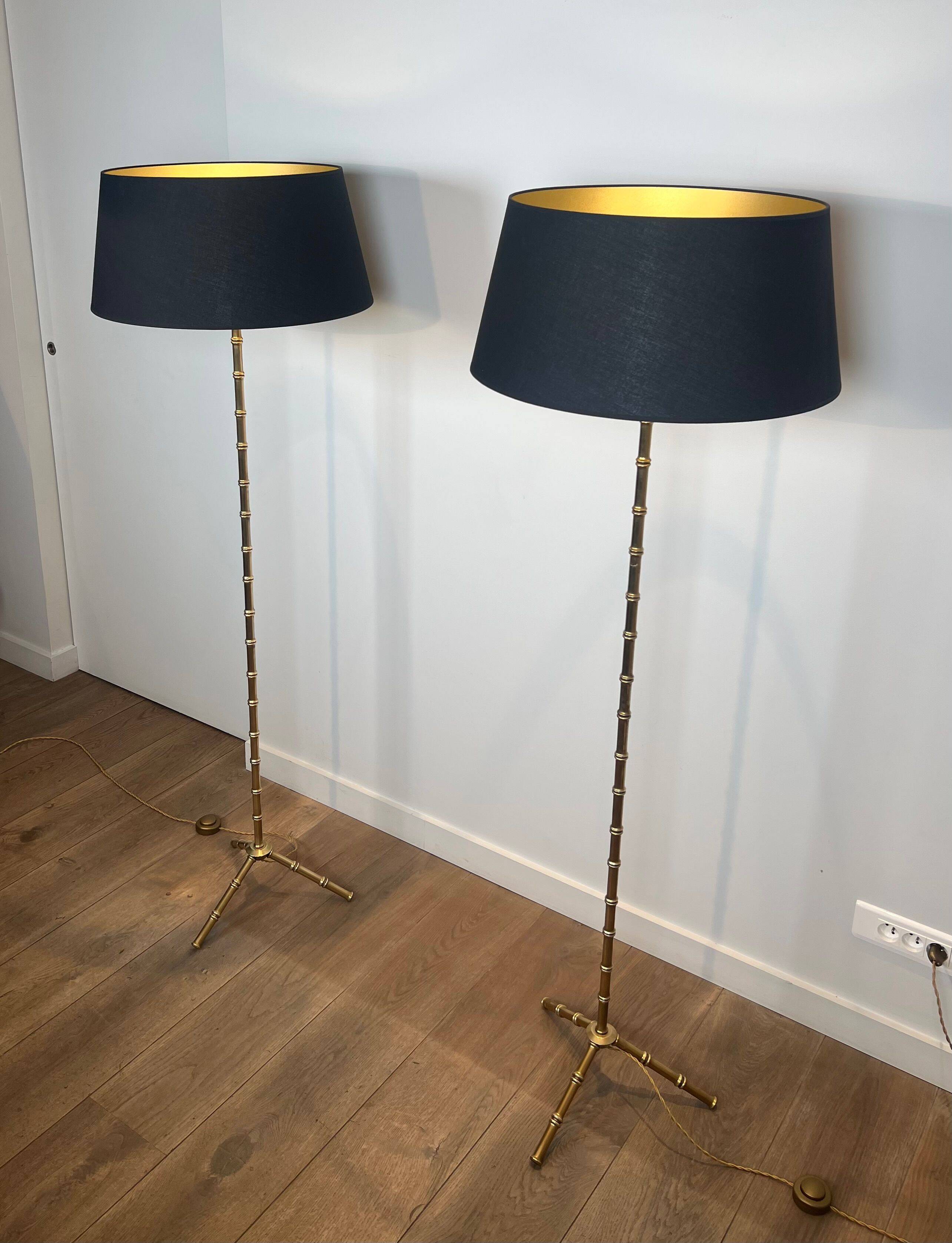 Pair of parquet floor lamps in faux-bamboo style in bronze and brass by Jacques Adnet.