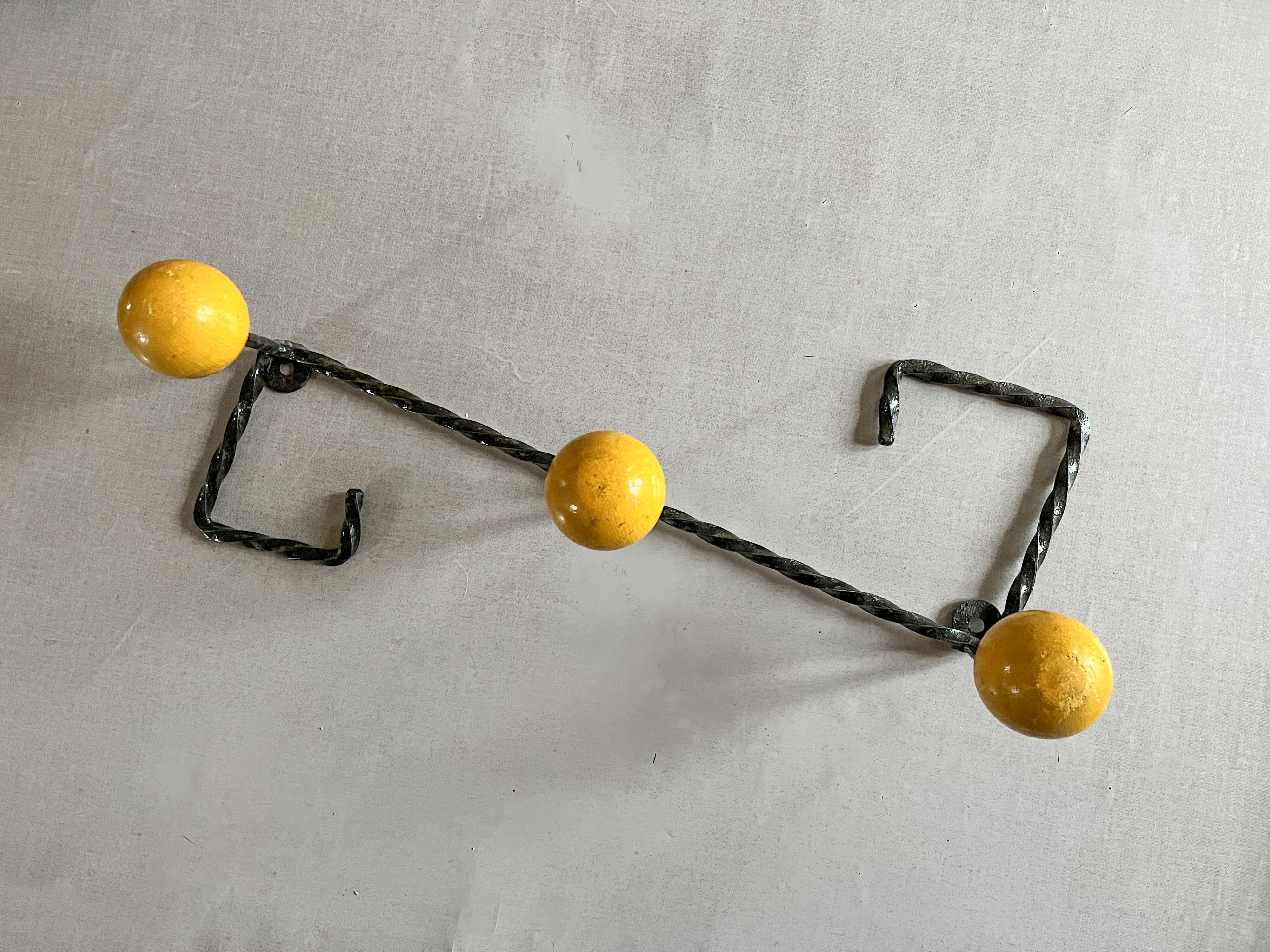 Wall-mounted coat rack in metal and wood with 3 hooks, antique item.