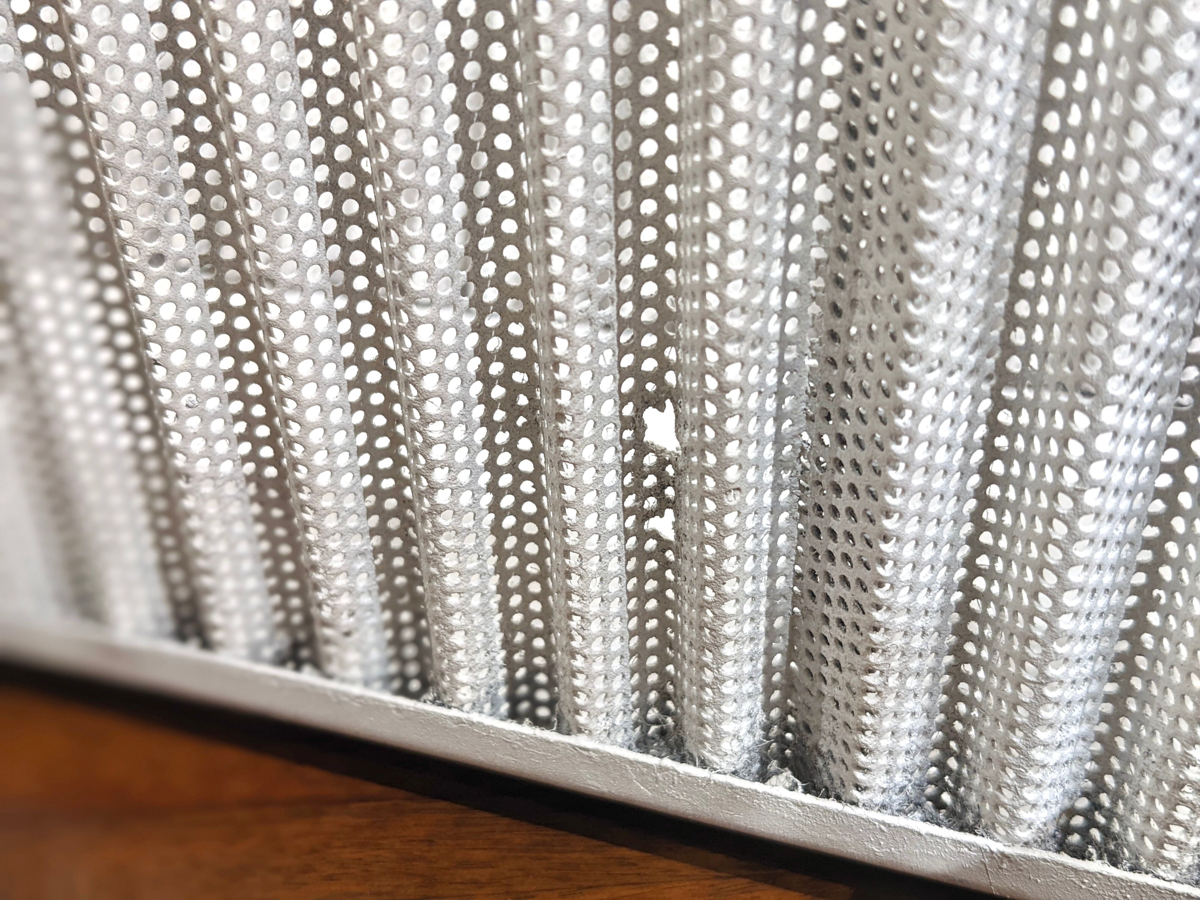 White perforated sheet metal planter by Mathieu Mategot