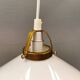 A set of hanging lamps in milky white opal glass with brass top.