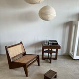 Reclined armchair in canned teak in natural wood