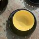 Coffee service composed of 5 cups and saucers in black earthenware and different colored interiors