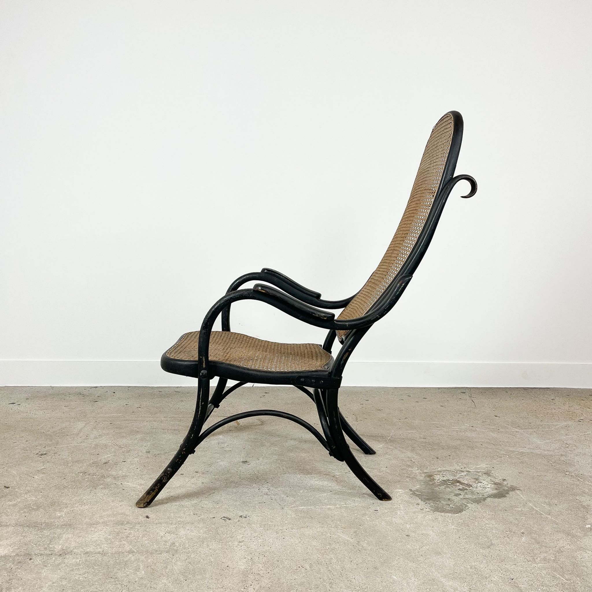 Antique black bentwood and cane lounge armchair by Thonet 19th century