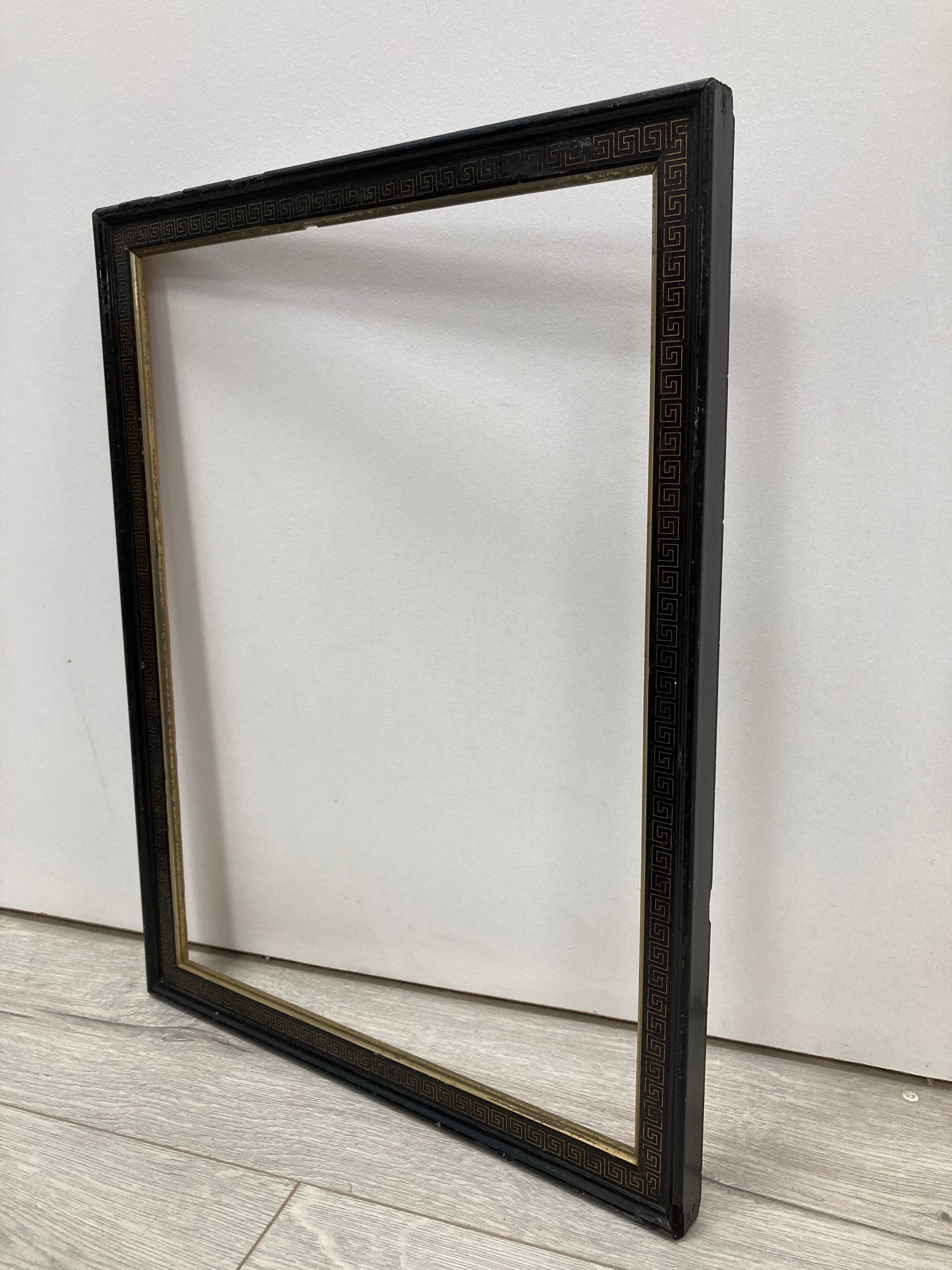 Black and gold frame decorated with Greek frieze decoration